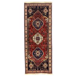 Fine Persian Qashqai crimson and navy ground runner, three large medallions filled with ge...