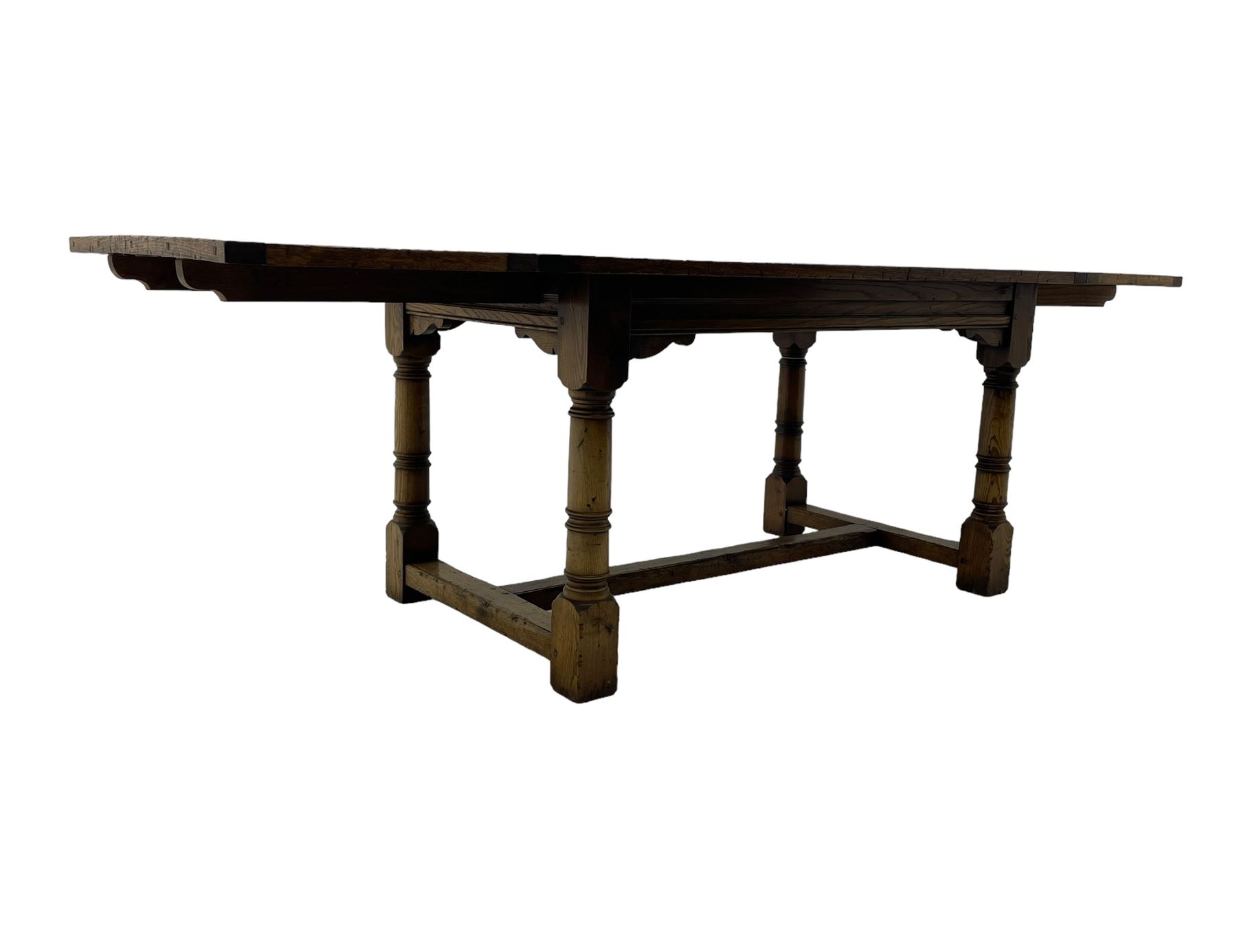 Oak refectory dining table, rectangular three plank top with cleated ends, two additional leaves, on turned supports united by H-stretchers 