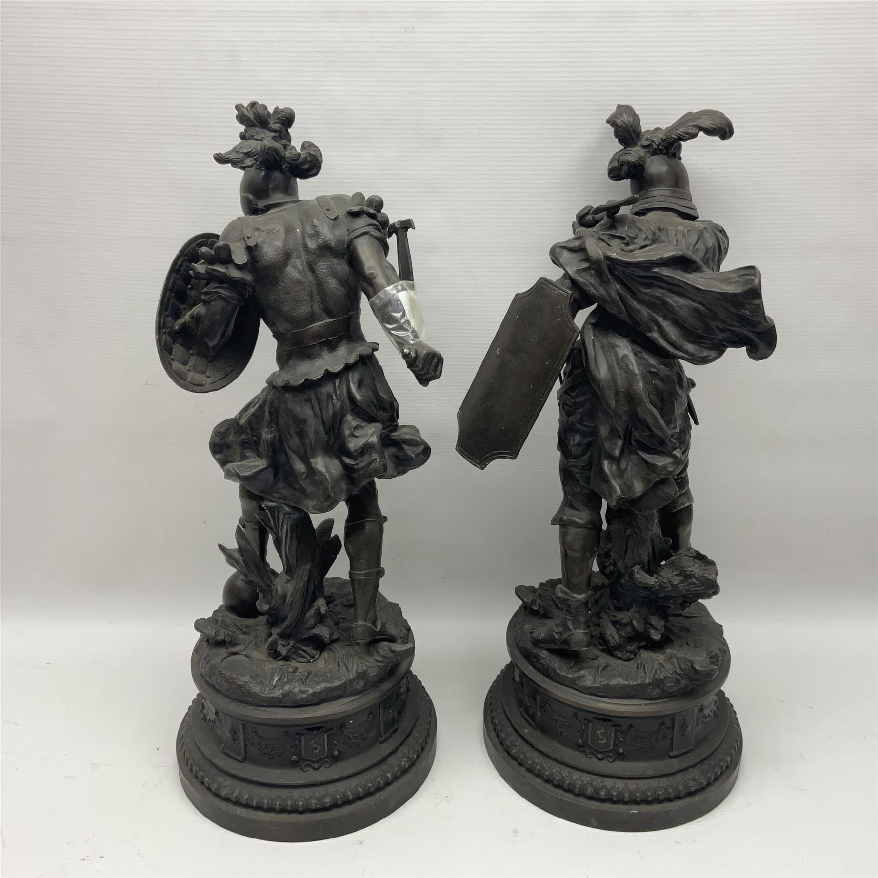 Pair spelter warriors, both with shields with a naturalistic ground and a plinth with relief decoration, H51cm