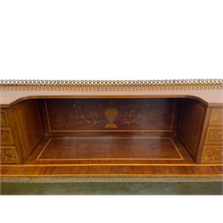 Edwardian inlaid mahogany writing desk, raised galleried back over inlaid central urn with scrolling leafy branches and six small drawers, satinwood banded rectangular moulded top with tooled leather inset, fitted with five drawers, the drawer facias inlaid with scrolling foliage and satinwood banding, square tapering supports inlaid with trailing bell flowers, on brass and ceramic castors 