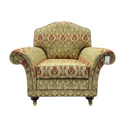 Traditional design two seat sofa, high back with scrolled arms, upholstered in beige fabric with red and green damask motifs, on castor supports (L178cm, D100cm, H89cm); matching armchair (L109cm, D89cm, H89cm)