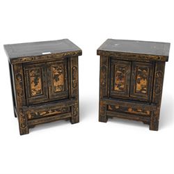 Pair of Chinese black lacquered storage cabinets, rectangular top over two panelled doors,...