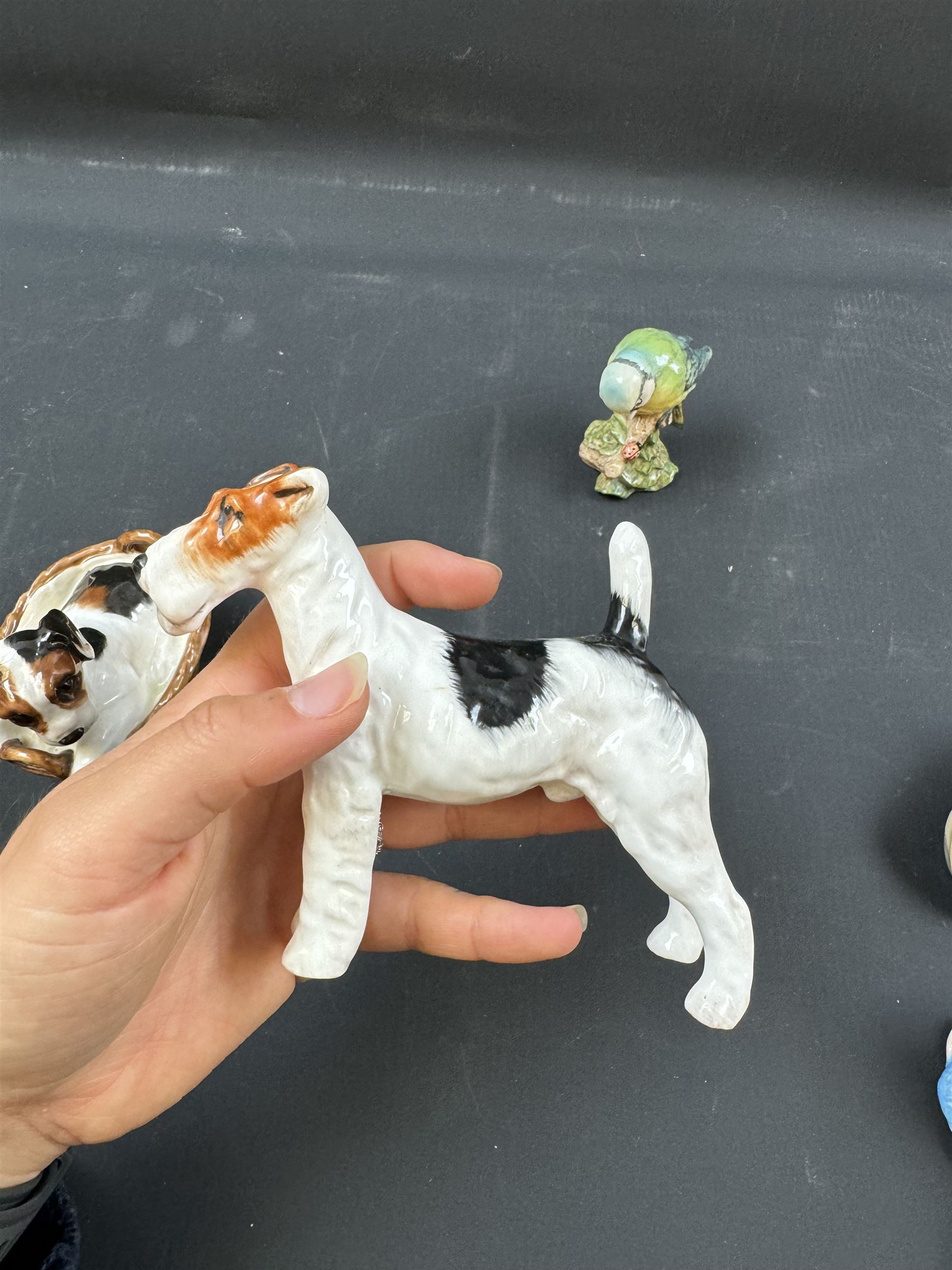 Two Royal Doulton figures of puppies in baskets, together with Beswick horse and other animal figures