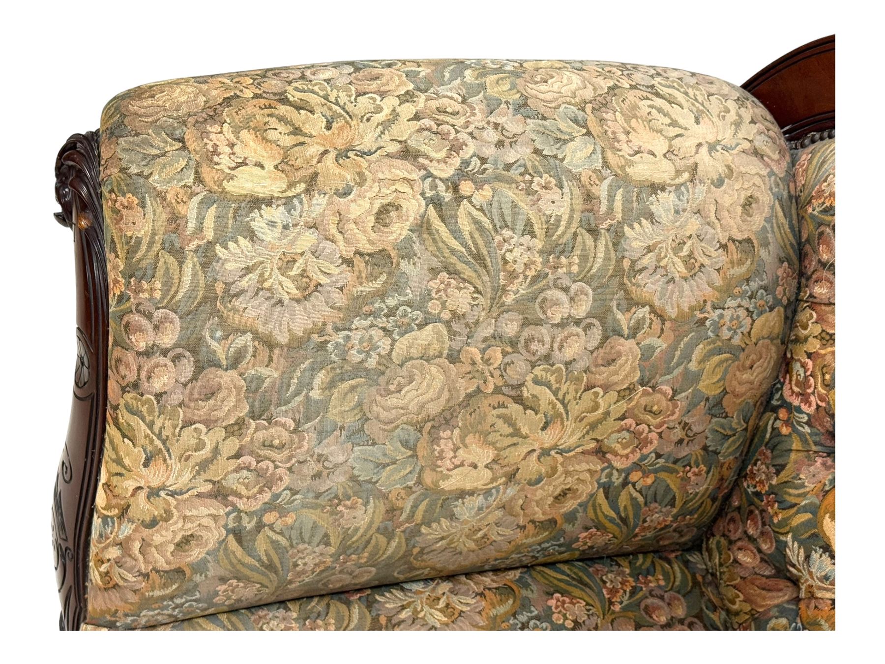 Victorian Aesthetic Movement mahogany framed chaise longue, shaped carved back over acanthus scrolled arm terminal, upholstered in floral patterned tapestry fabric with sprung seat, on turned and fluted supports with castors