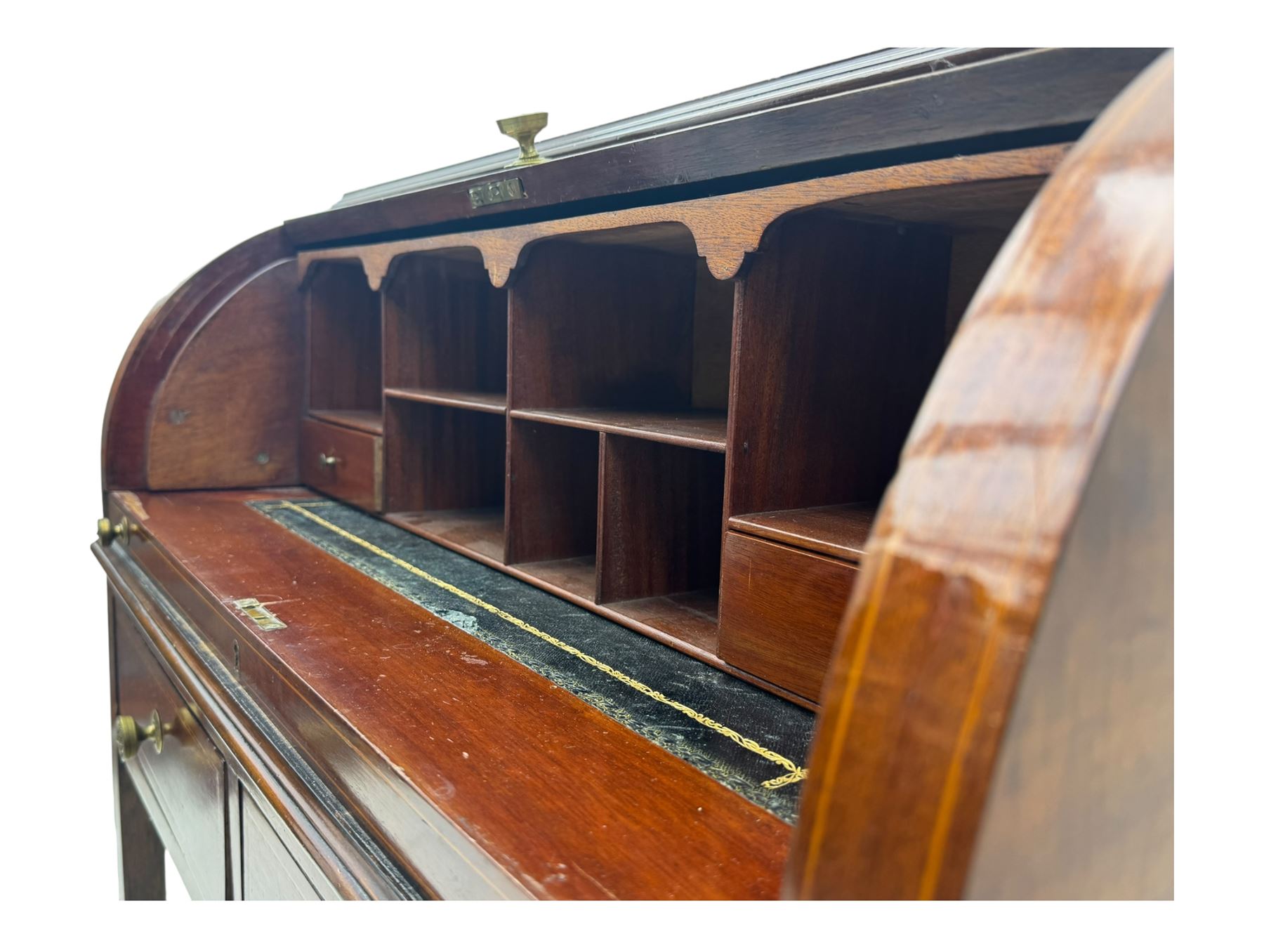 Edwardian inlaid mahogany roll-top desk, cylindrical lid enclosing fitted interior with pigeonholes, drawers and retractable writing surface, over two drawers with brass pull handles, on tapered supports with brass and ceramic castors