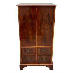 Wade - yew wood hi-fi cabinet, moulded rectangular hinged top over double-door cupboard with figured veneer, enclosing three adjustable shelves, lower section fitted with two cupboards to resemble four drawers, enclosing three drawers and open storage