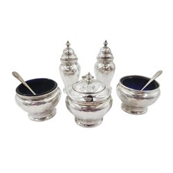 1930s five piece silver cruet set, comprising pepper shakers, open salts and mustard pot and cover, with three silver condiment spoons, hallmarked Adie Brothers Ltd, Birmingham 1932, the salts and mustard each with blue glass liners 