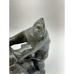 Inuit soapstone carving, of a hunter and a polar bear, circa 1960, H19cm 