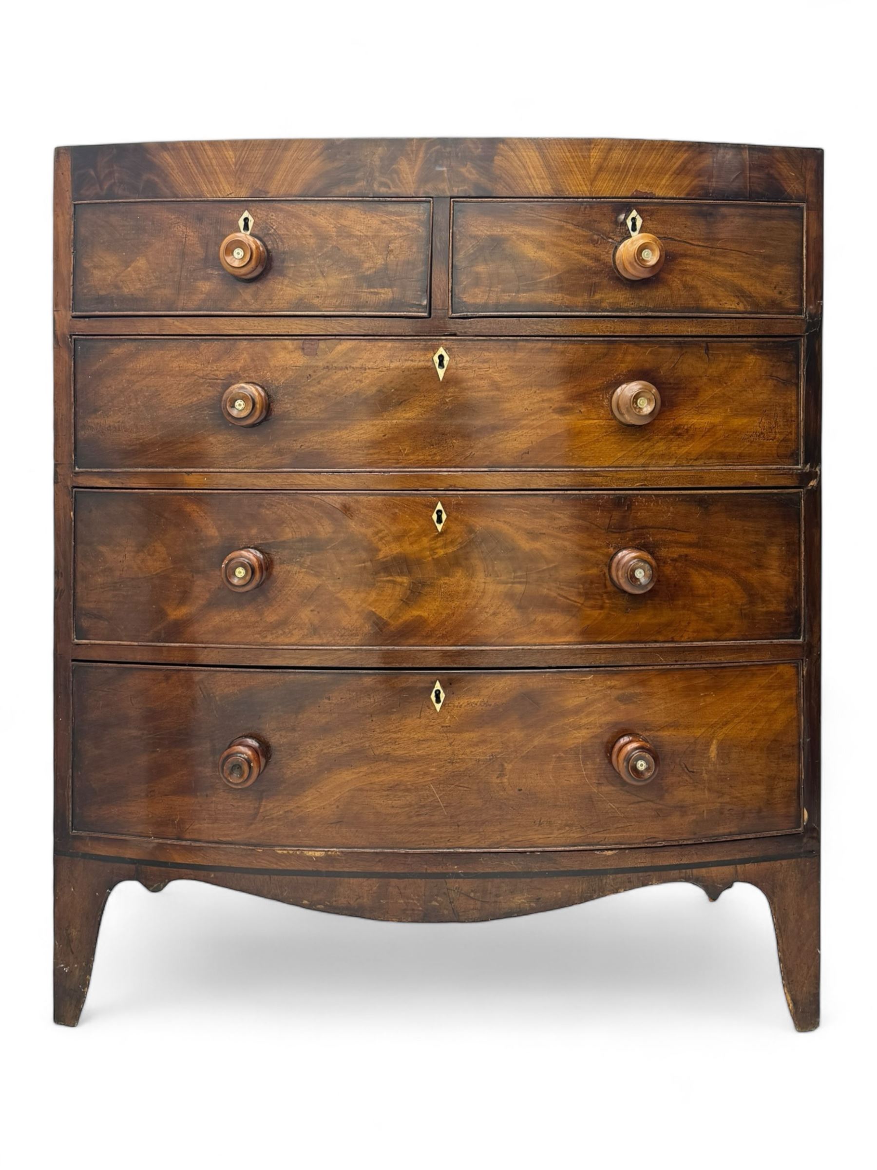 Early 19th century mahogany bow-front chest, fitted with two short over three long graduated cockbeaded drawers, each with turned wooden knobs and bone escutcheon, raised on splayed bracket supports