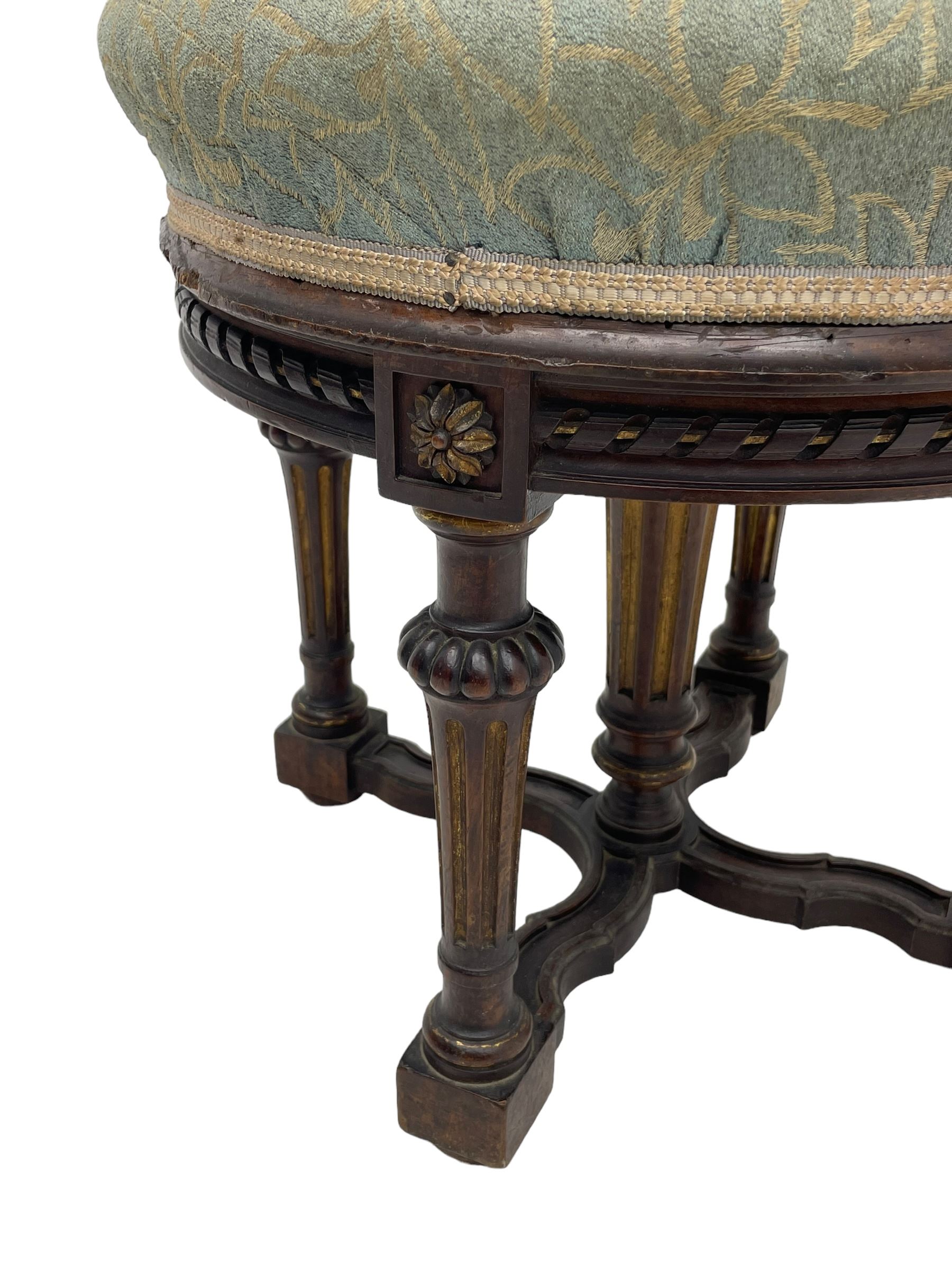 Holland & Sons (London: 1843-1942) - mid-to-late 19th century French design stool, circular form with upholstered cushioned seat in foliate pattern fabric, on lobe carved turned and fluted supports united by shaped X-framed lower stretchers 