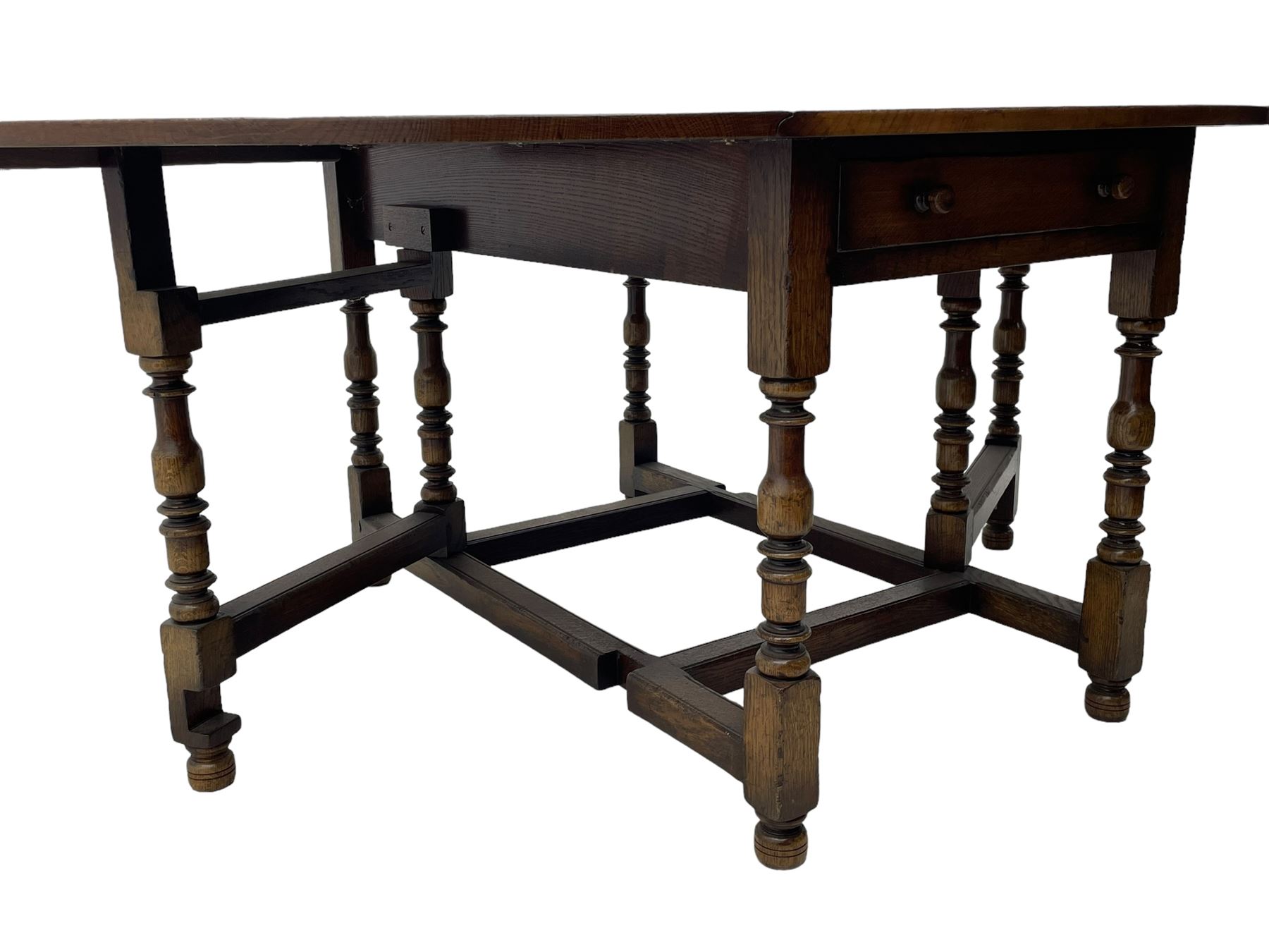 Titchmarsh & Goodwin - 17th century design oak drop leaf dining table, oval top with hinged drop leaves, single drawer to one side with applied makers label, baluster-turned supports united by stretchers