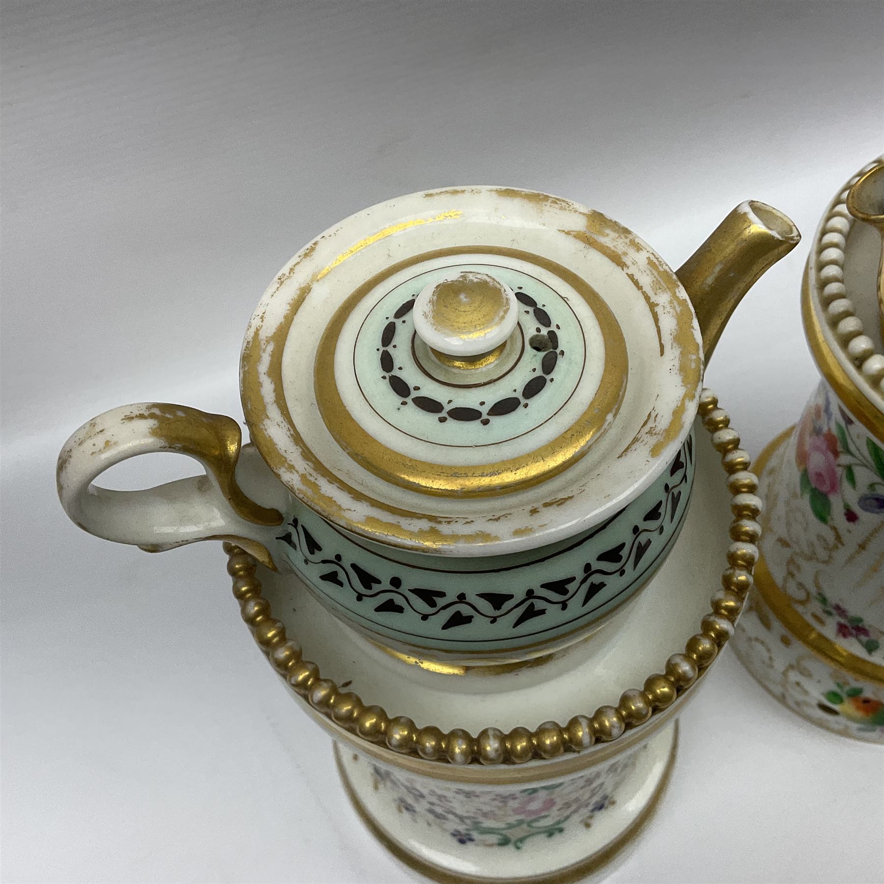 Two 19th century continental teapots and warmers, each teapot upon a cylindrical warming base, hand printed with floral sprigs, birds and insects, largest H22cm 