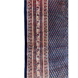 Large North-West Persian Arrak indigo ground carpet, the field decorated all-over with small Boteh motifs, multiple band border decorated with repeating geometric designs