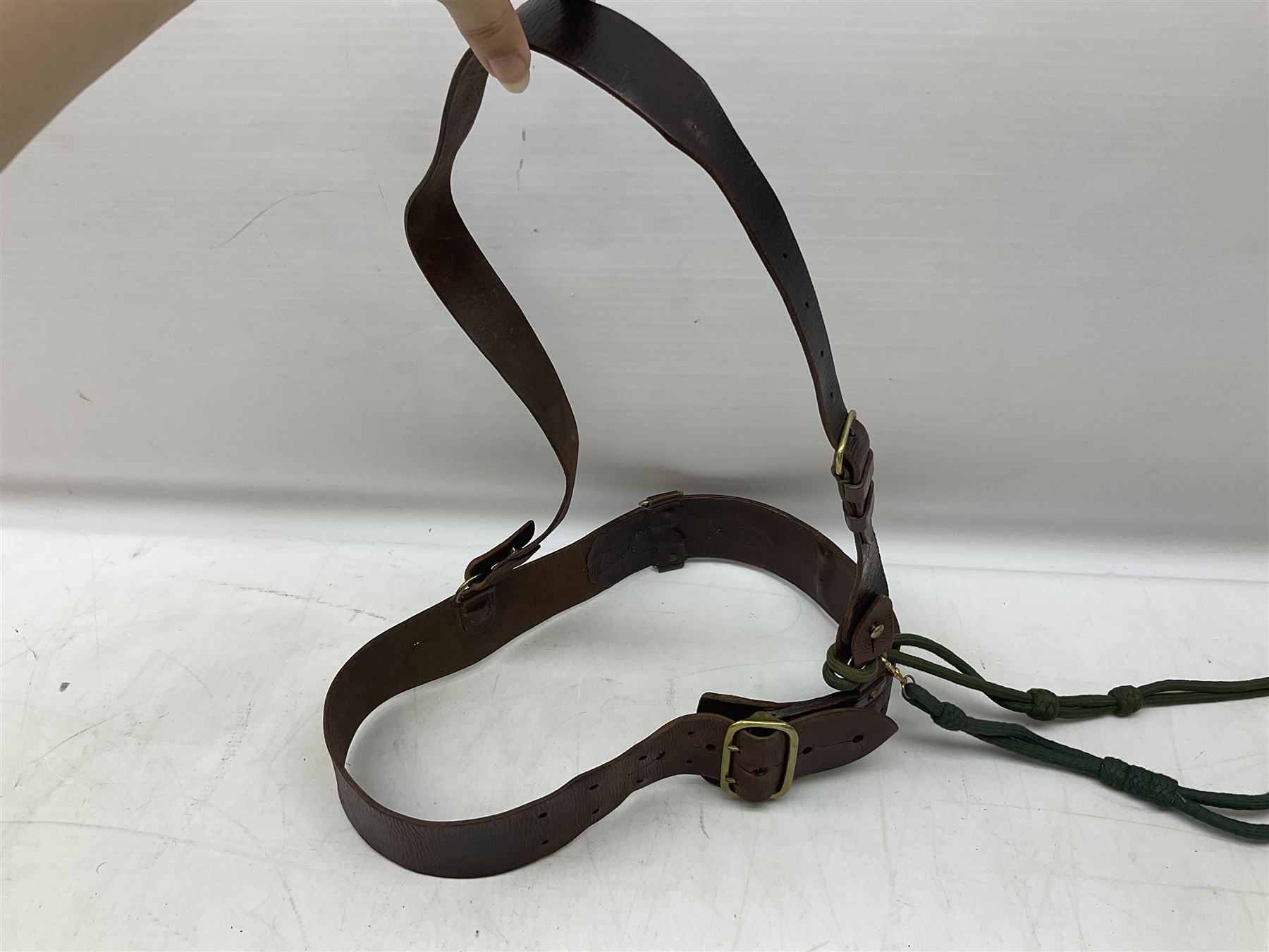 British Army Officers Sam Browne leather belt with shoulder strap; and webbing belt with Potter London Staybrite buckle for 19th Regiment of Foot (Green Howards) with various markings (2)