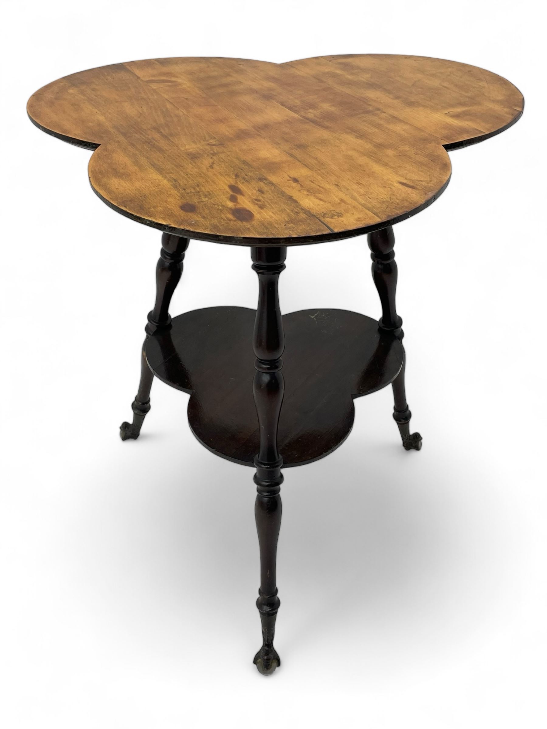 Late 19th to early 20th century stained beech 'Gypsy' table, trefoil or clover shaped top on turned supports united by undertier, on cast metal and glass ball feet 