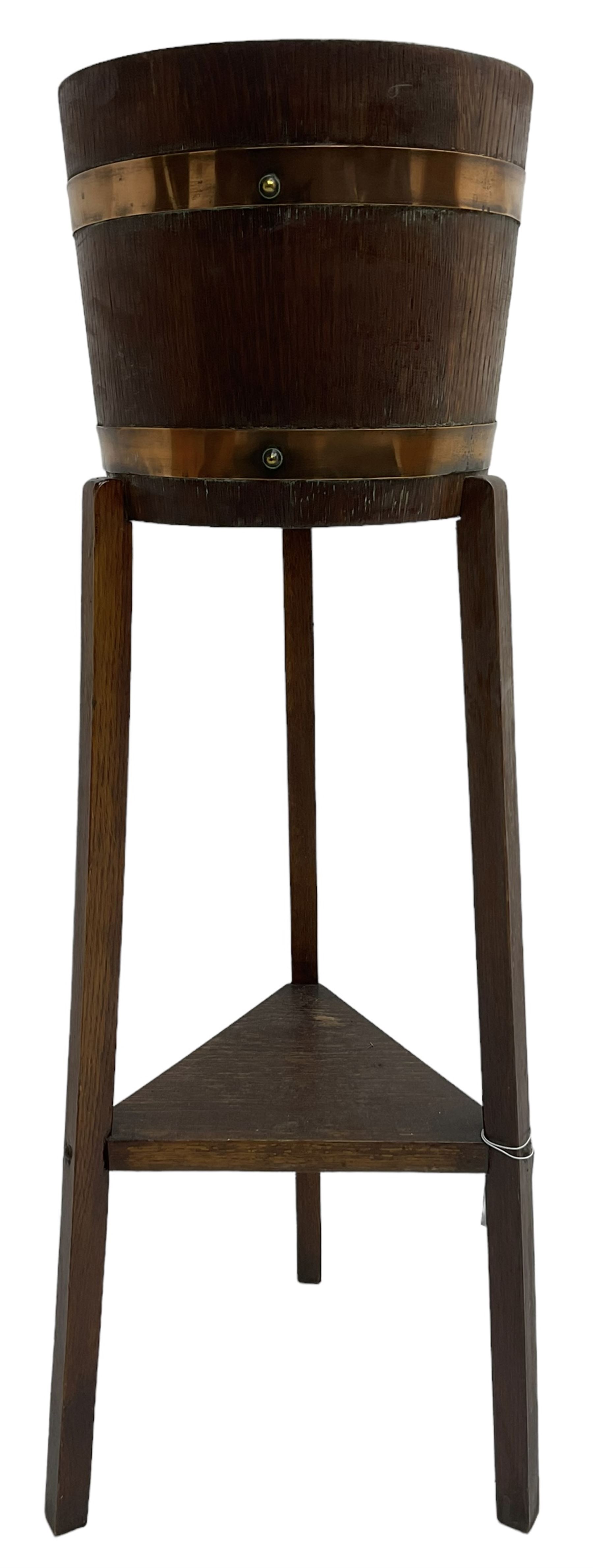 RA Lister & Co, Dursley - early 20th century oak jardinière plant stand, coopered barrel on three splayed supports united by undertier 