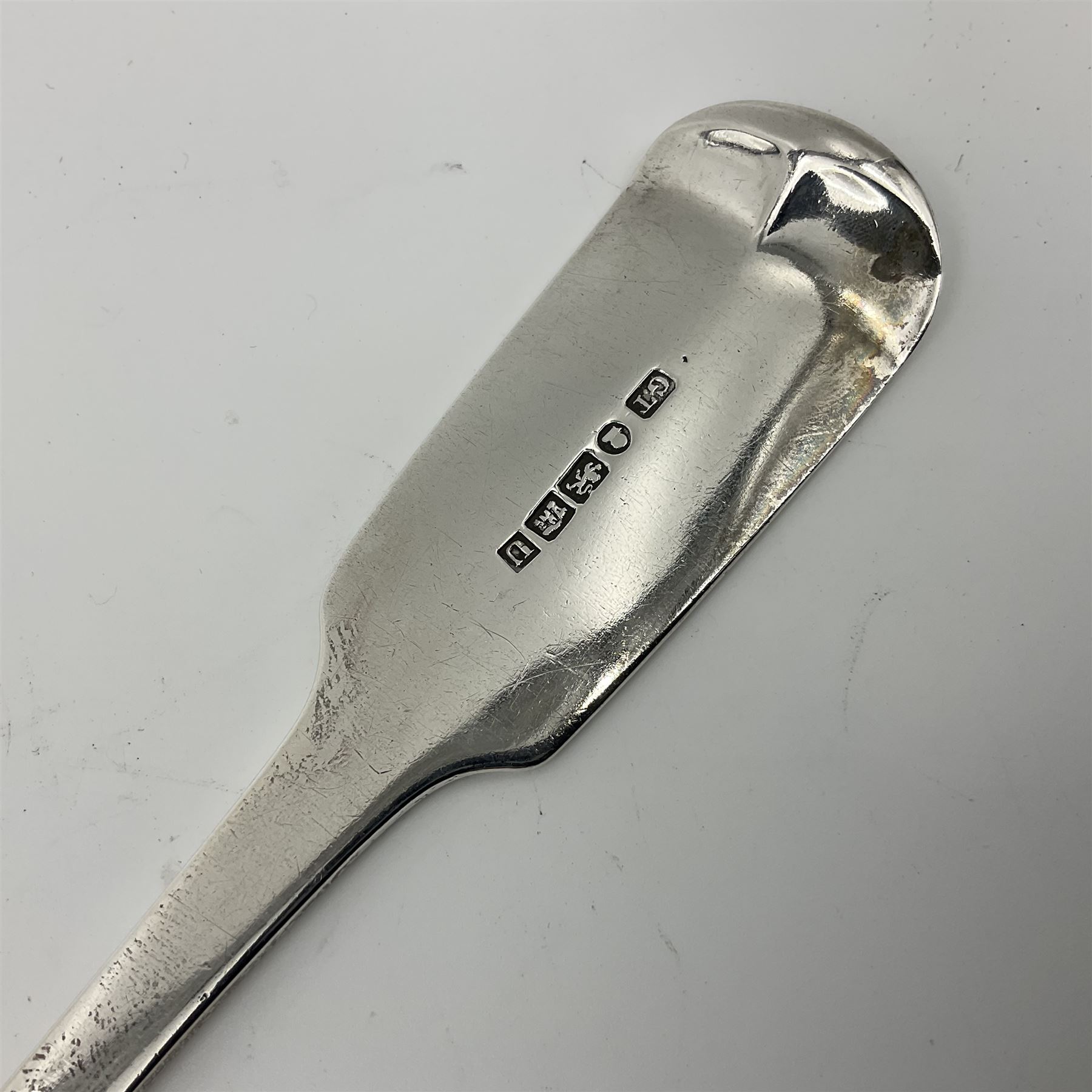 George III Exeter silver Fiddle pattern serving spoon, the terminal engraved with crest of a fist holding an arrow, hallmarked George Turner, Exeter 1816, L29cm