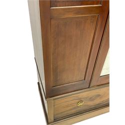 Edwardian inlaid mahogany wardrobe, projecting moulded cornice over central bevelled mirror glazed door, panelled uprights inlaid with trailing bellflowers and foliate decoration, the skirted base fitted with single drawer 