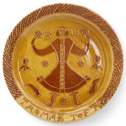 Large slipware charger in the style of Thomas Toft, centrally decorated with a male figure and the initials R.W, within a cross-hatched border, D44cm