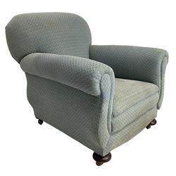 20th century traditional shape armchair, curved back and rolled arms, upholstered in light blue patterned fabric, on turned front feet