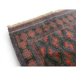 Baluchi indigo ground rug, the field decorated with all-over crimson and indigo lozenges, enclosed by geometric guard lines