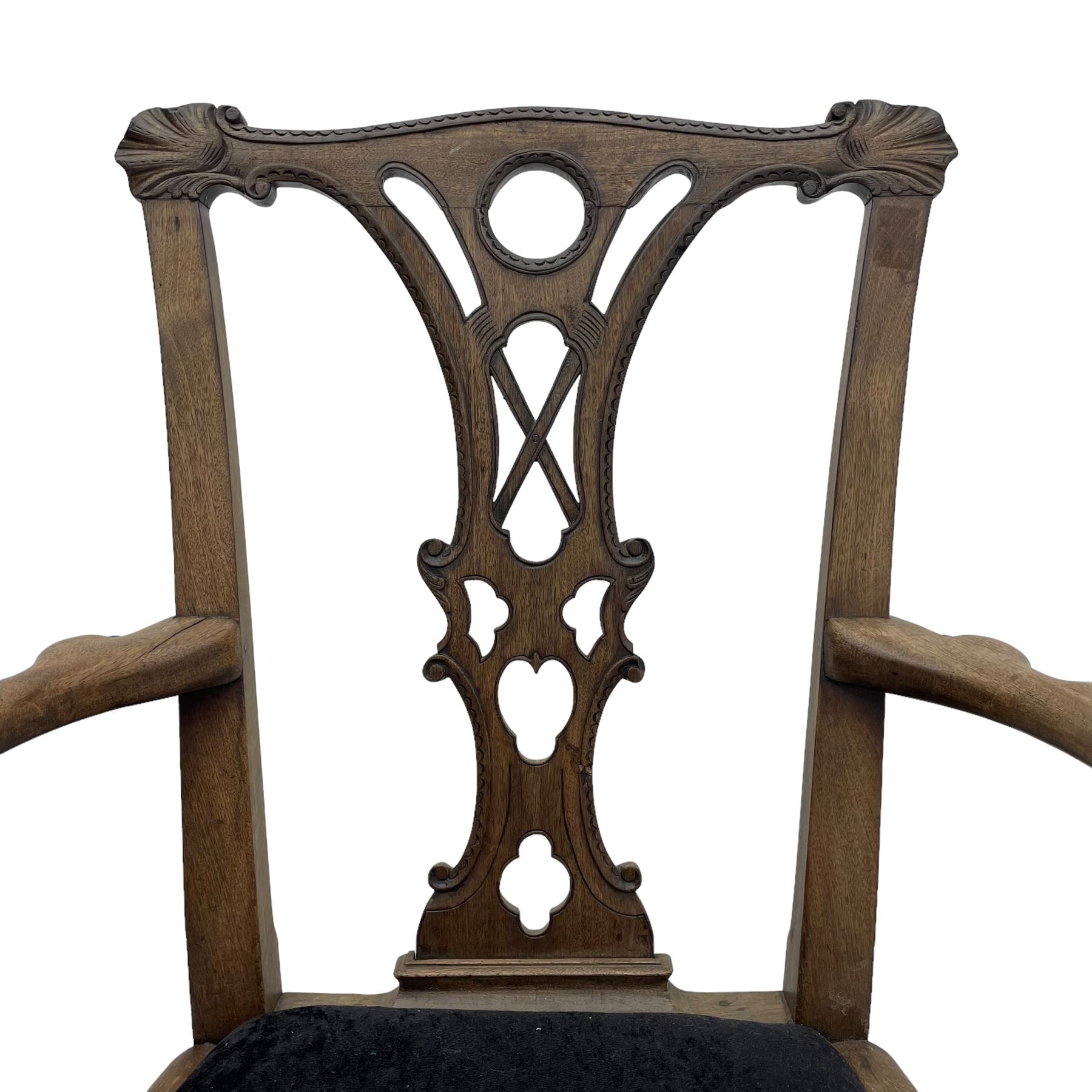 Unusual 18th century mahogany elbow chair, the shaped cresting rail with projecting shell carved ears, pierced and scroll carved splat over drop-in upholstered seat, shaped arms with ball and claw carved terminals, the seat rails carved with shell cartouches, on foliate carved cabriole supports with ball and claw feet 