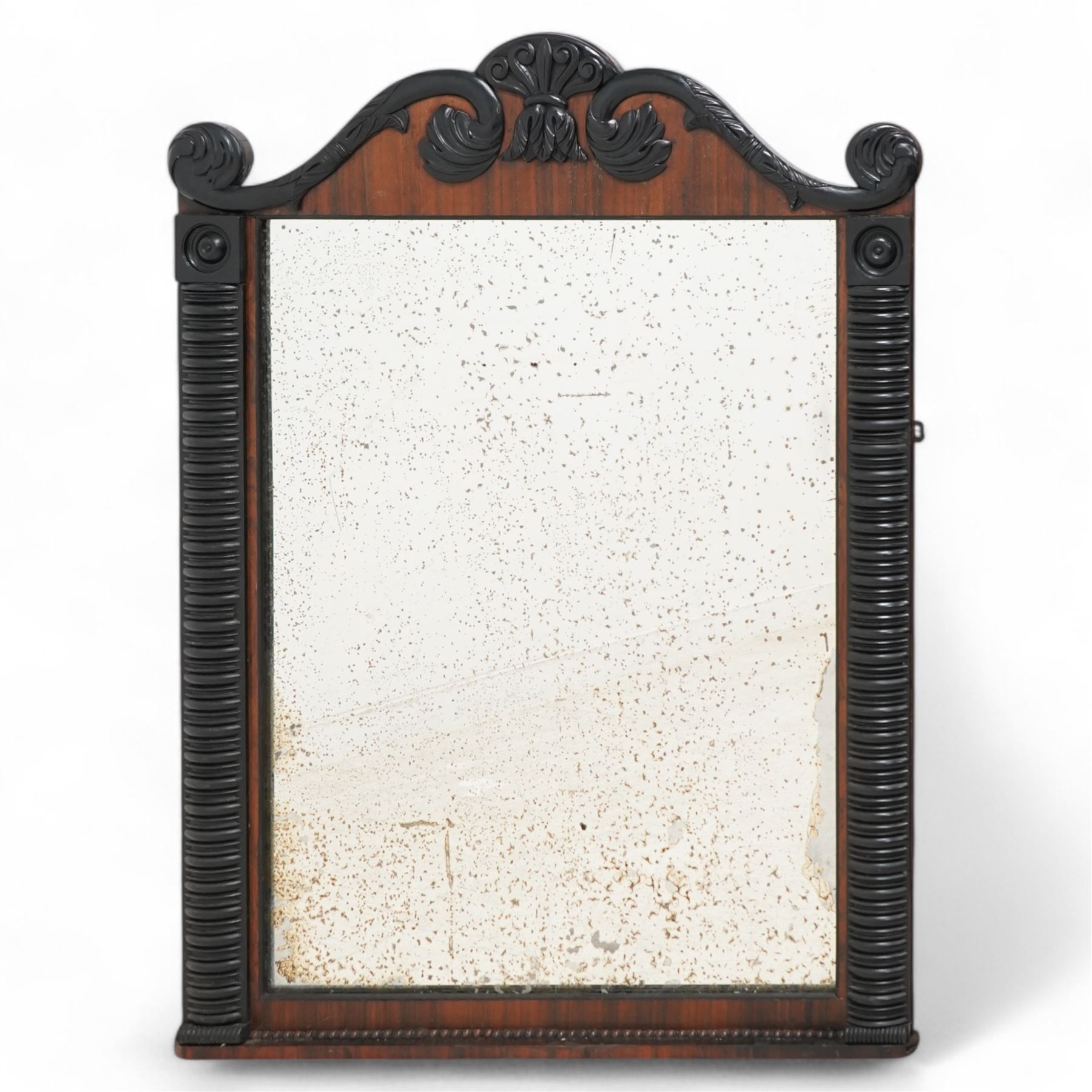 Early 19th century rosewood and ebonised overmantel mirror, scroll shaped pediment decorated with ebonised acanthus carved applied mounts, rib turned upright mounts enclosing rectangular mercury mirror plate, applied lower beaded edge 