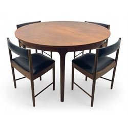 Mid-20th century teak extending dining table, circular top with pull-out extension and con...