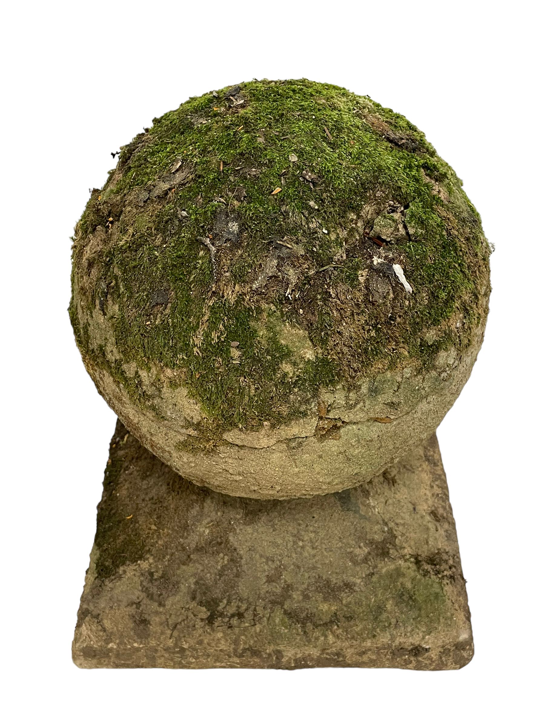 Set of three weathered cast stone gate post finials, circular orb on step-canted square base 