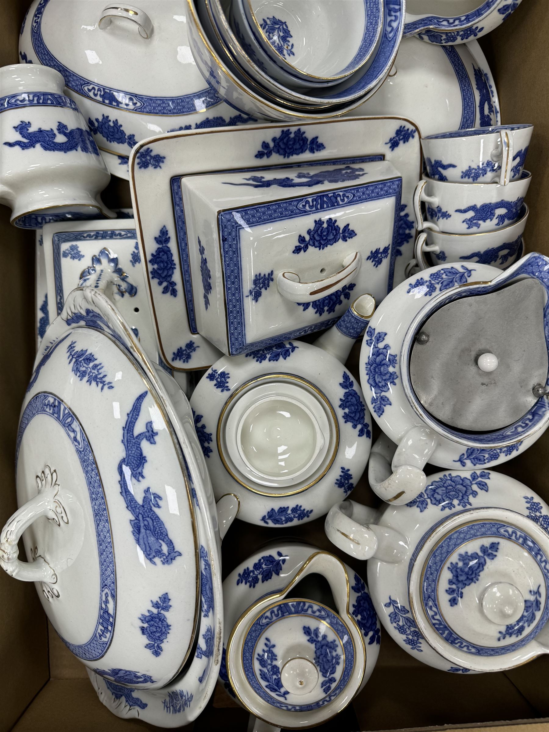 Extensive tea and dinner service of Booths and Cauldon dragon pattern, including, teapots, coffee pots, jugs, toast racks, bowls, dinner plates, platters, soup tureen etc 