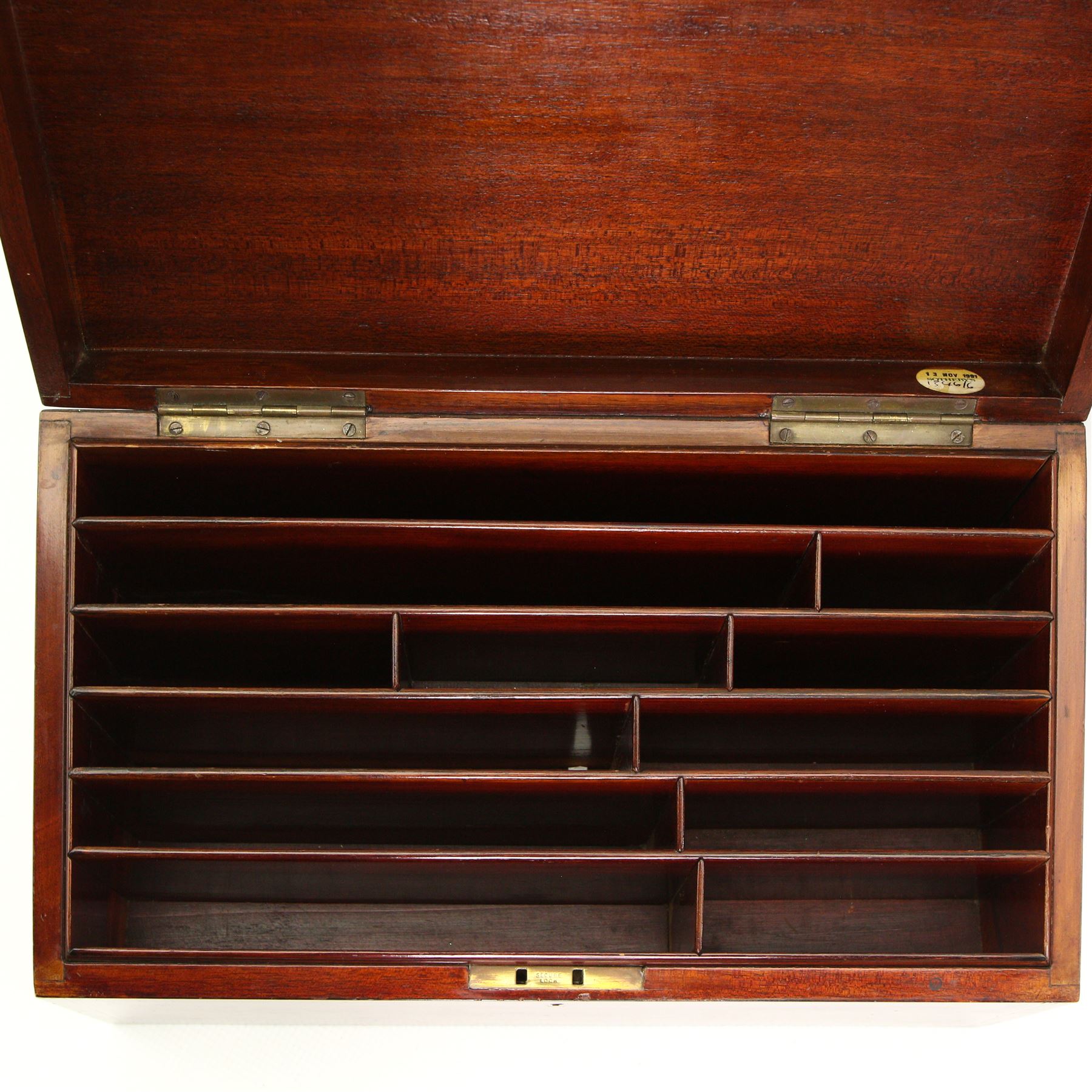 19th century Mahogany stationery box inlaid with boxwood stringing, the hinged sloping lid inset with a brass plaque engraved with initial 'R', divided interior with Sothebys lot label 'November 1991' W39cm