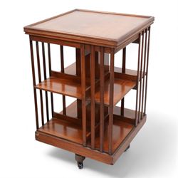 Edwardian mahogany revolving bookcase, square form with moulded top, two tiers with vertical moulded slats, on brass and ceramic castors 