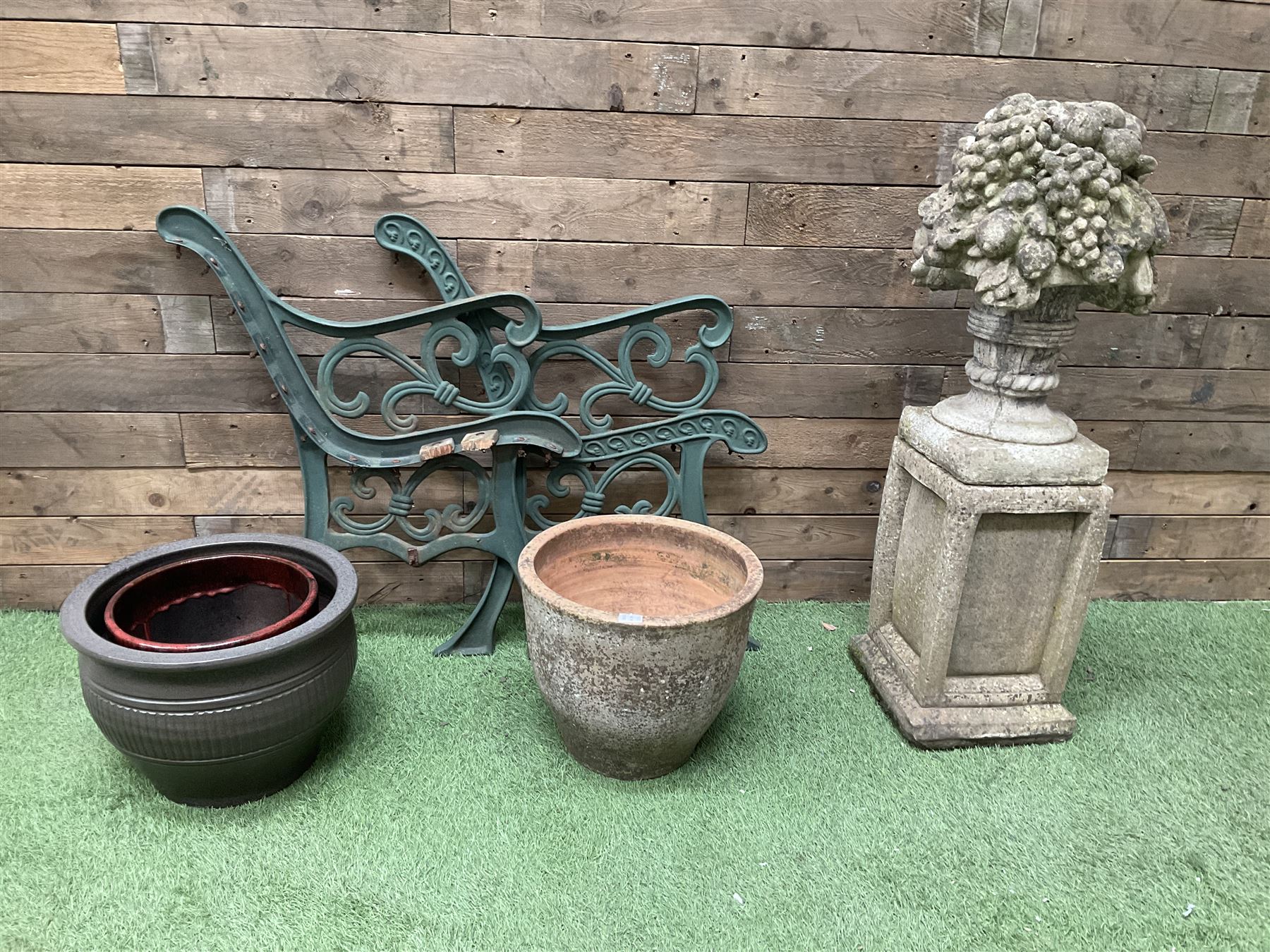 Cast stone garden fruit centrepiece on square base, pair of cast iron bench ends, and three planters - THIS LOT IS TO BE COLLECTED BY APPOINTMENT FROM DUGGLEBY STORAGE, GREAT HILL, EASTFIELD, SCARBOROUGH, YO11 3TX