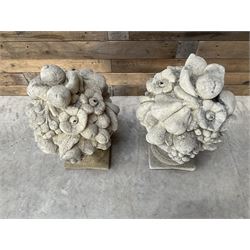 Pair of cast stone garden wall or gate finials depicting Fruit Piers, raised on separate circular squat column with plinth base