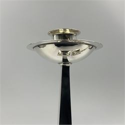 Pair of Arts & Crafts style silver plated candlesticks, by James Dixon & Sons, modeled after a design by Jan Eisenloeffel, each with square spreading base with strap-work detail, leading to a tapering square column with plain socket above a circular dished drip pan, each with makers mark, H22cm