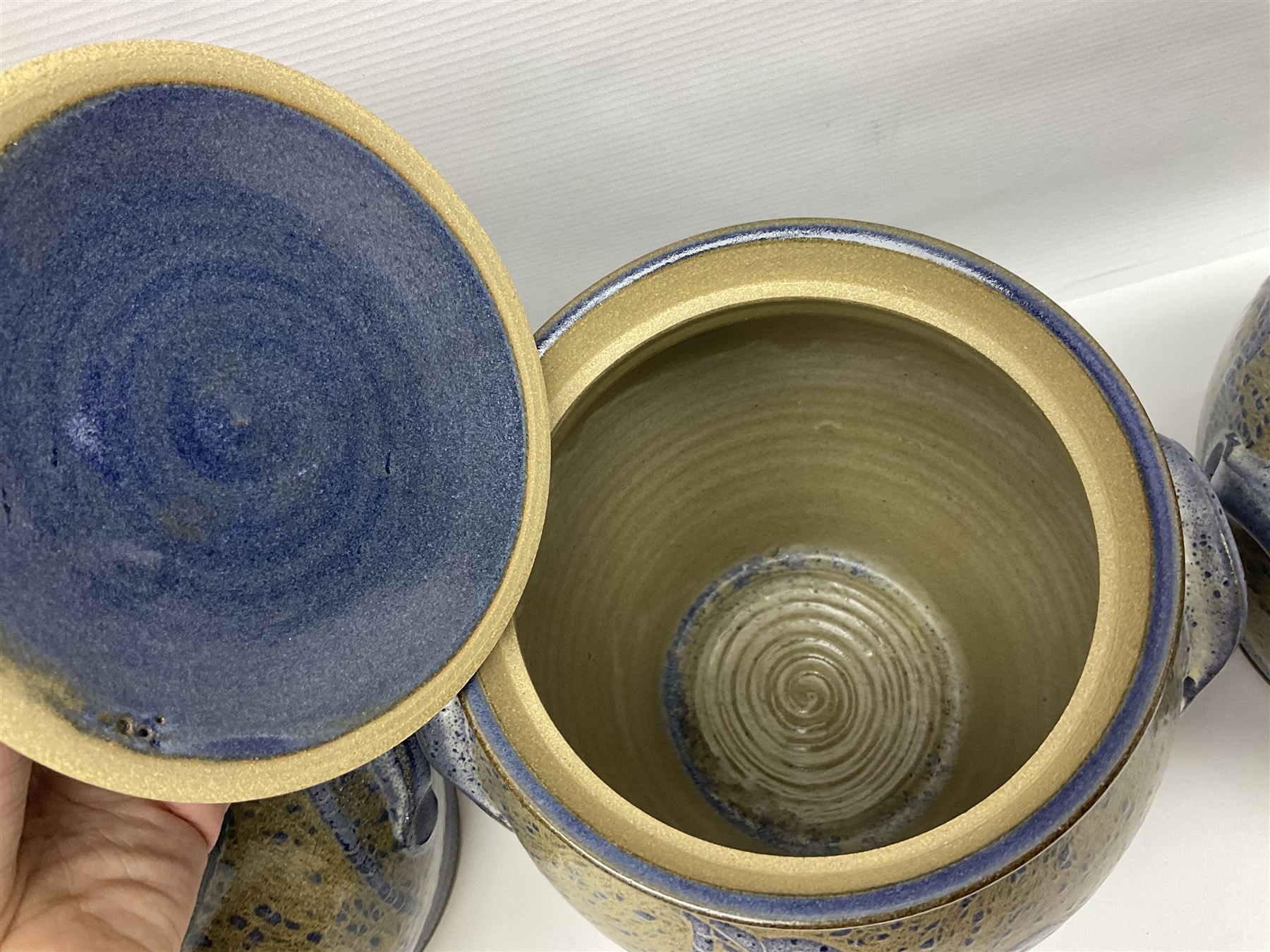 John Egerton (c1945-): set of five studio pottery stoneware twin handled jars with covers, decorated with blue birds upon a brown mottled ground, H20cm