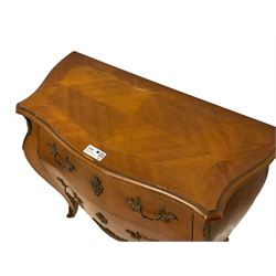 Late 20th century French design walnut bombe chest, shaped moulded top with quarter-matched veneers within crossbanding, fitted with two drawers with foliate cast metal handles and escutcheons, on tapering supports with ornate cast caps 