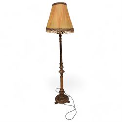 Neoclassical design gilt standard lamp, the turned ropetwist column decorated with egg-and-dart motifs and reeded elements, on circular base with scroll feet, with associated shade