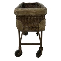 Early 20th century GPO wicker and hide bound postal trolley, on a cast iron base with castors