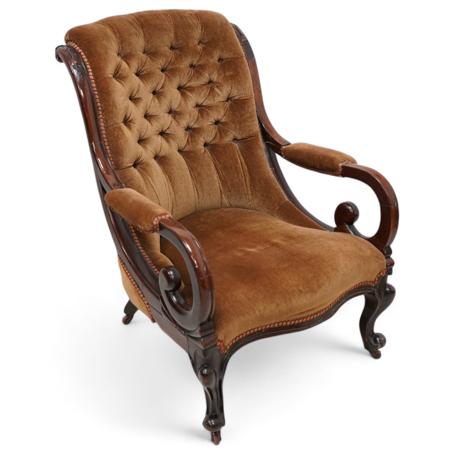 Victorian mahogany framed drawing room chair, scrolled back with bell-flower mouldings over scrolled arm terminals, upholstered in buttoned hazelnut brown fabric with sprung seat, cabriole supports on castors