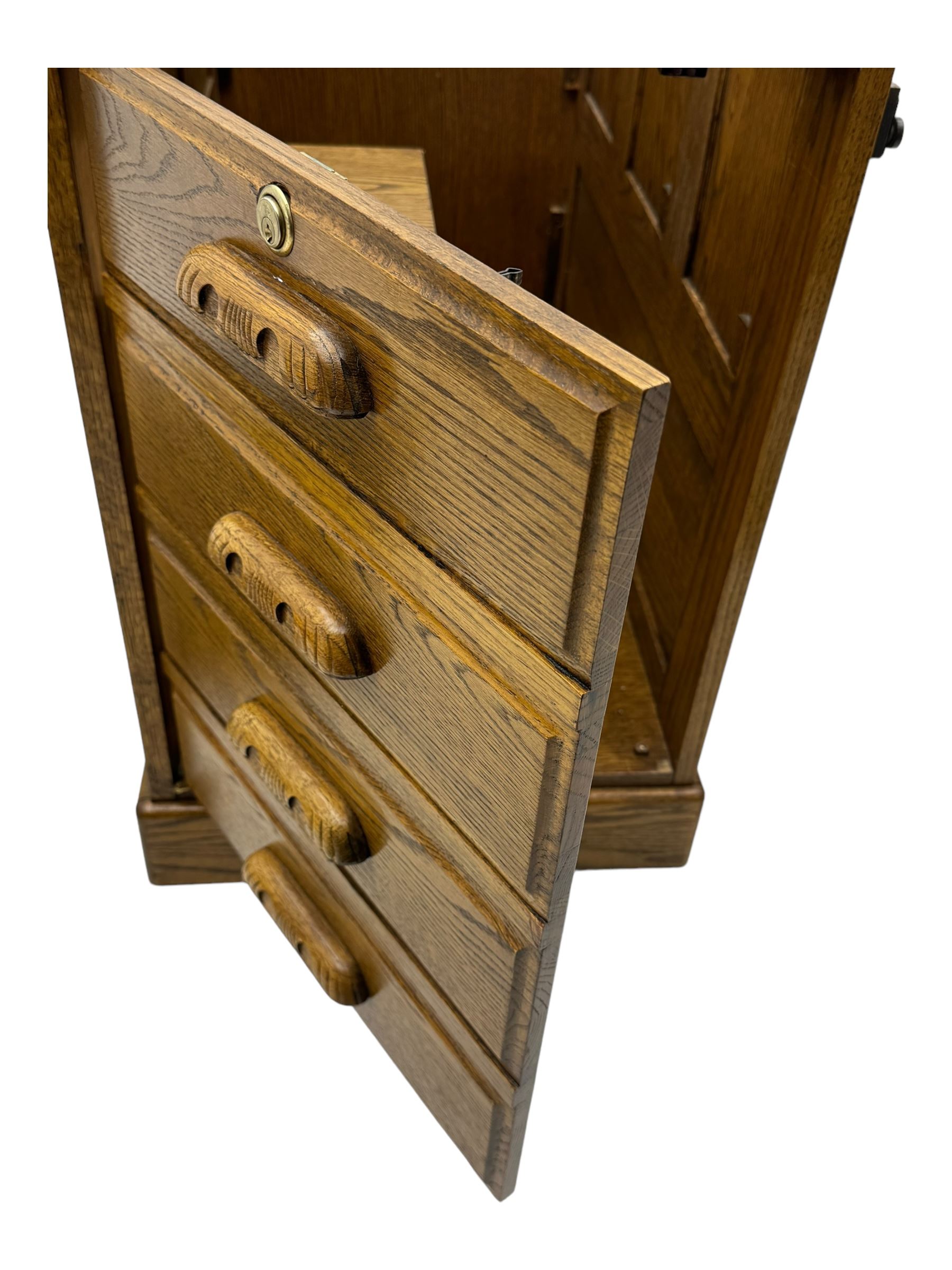 Early 20th century oak tambour roll-top desk, the top with fitted interior including drawers, pigeonholes and compartments, the twin pedestals fitted with four drawers with carved handles, supported by plinth base 