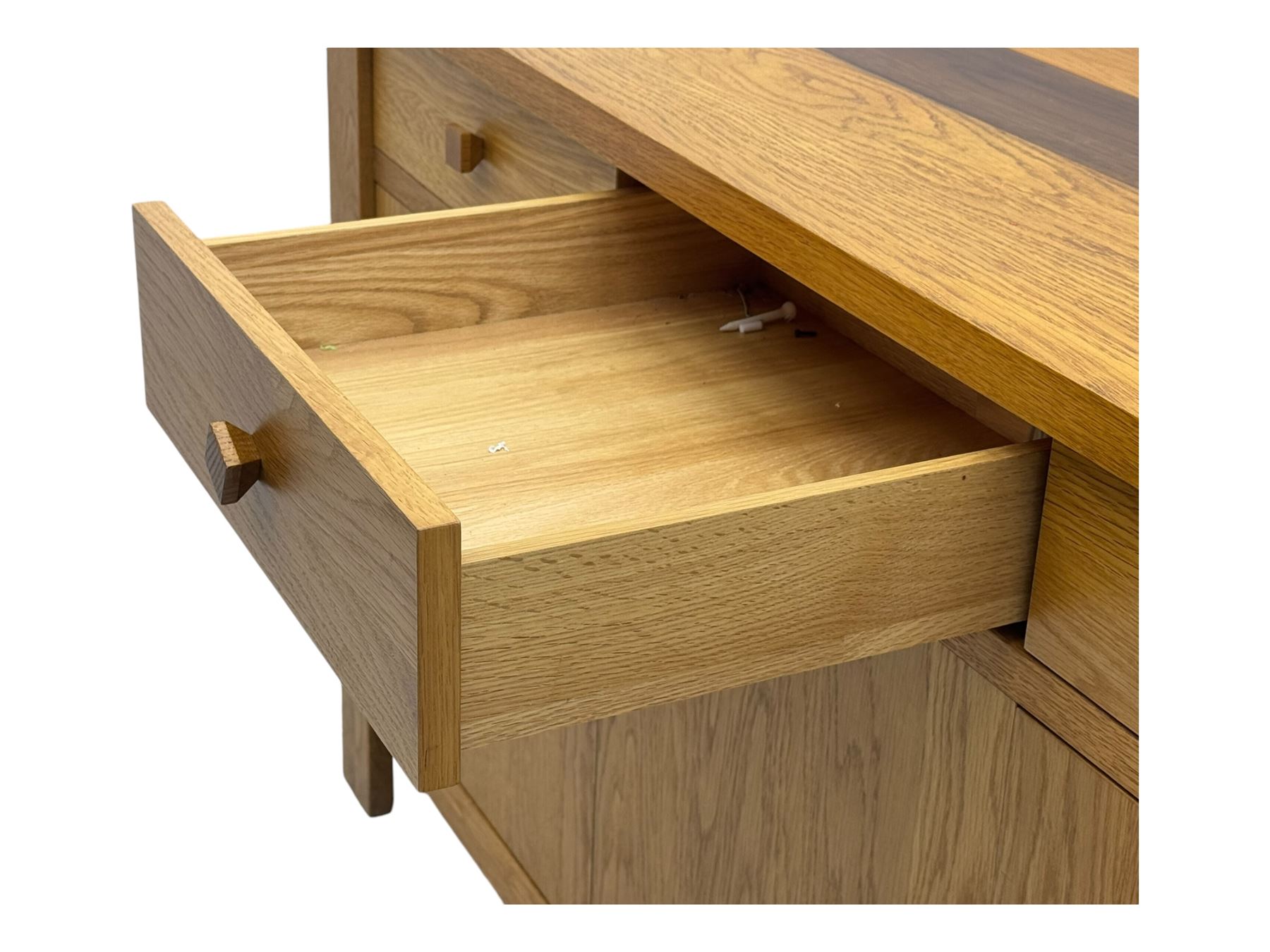 Contemporary oak sideboard, rectangular top with central contrasting plank, over three frieze drawers and three cupboards with enclosed shelving, on rectangular stile supports