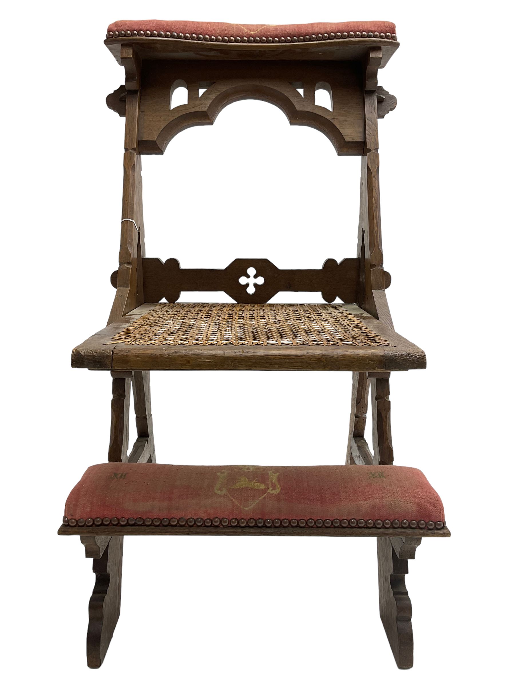 Late Victorian oak metamorphic prie-dieu chair, ecclesiastical design with pegged construction, upholstered kneel rest and top rest, hinged cane work seat