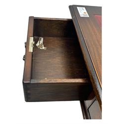 20th century mahogany twin pedestal desk, moulded rectangular top with red leather inset with gilt tooled border, central drawer over kneehole flanked by two banks of four graduating cockbeaded drawers, on plinth base