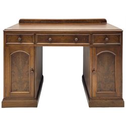 Victorian walnut twin pedestal desk or dressing table, raised back over quarter-matched veneered top, fitted with three drawers and two cupboards, enclosed by figured panelled doors, on moulded plinth base