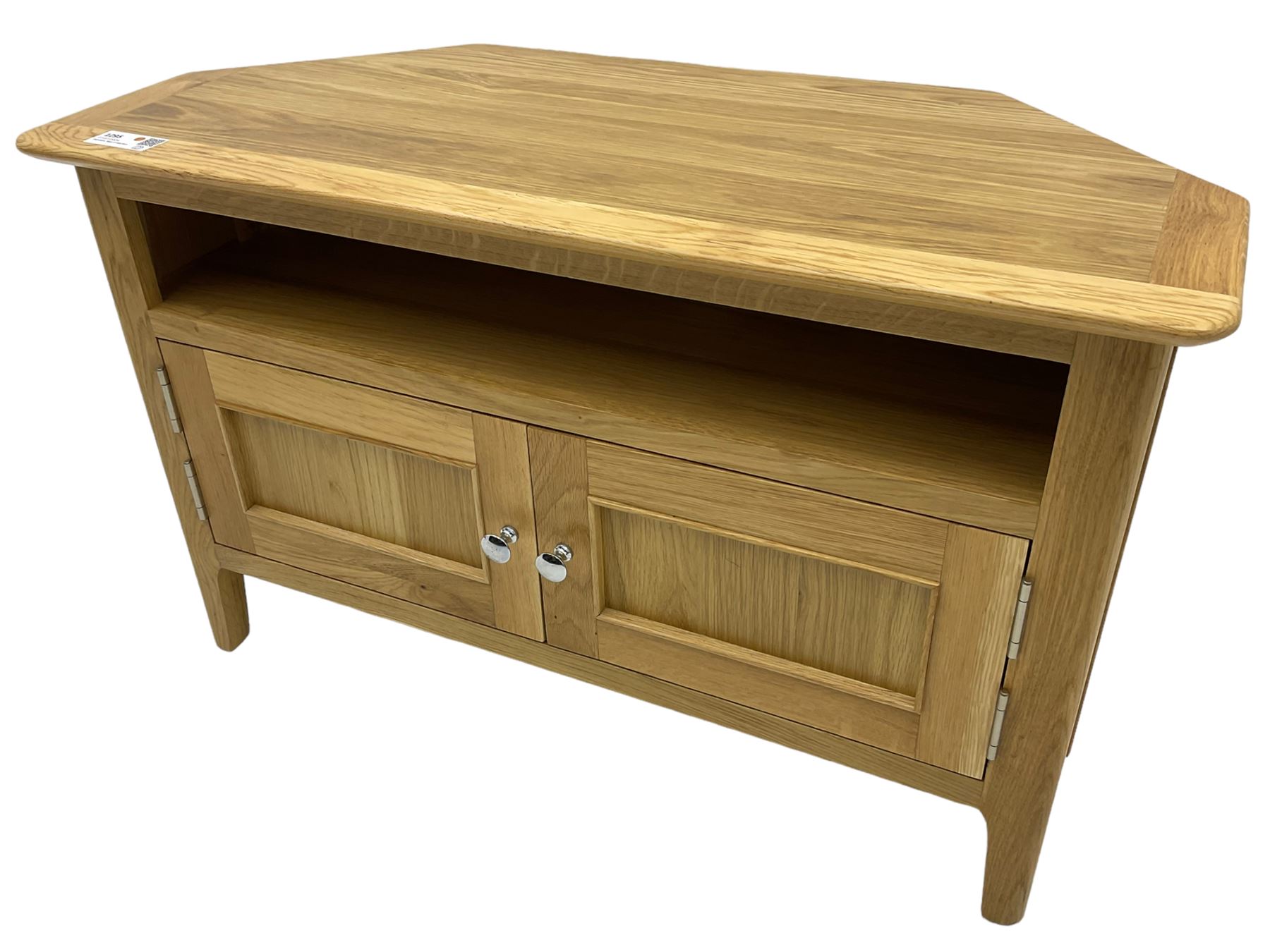 Contemporary light oak corner television stand, hexagonal top over recessed shelf, fitted with two panelled cupboard doors with chrome handles, on straight supports with rounded inner edges