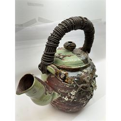 Very large Japanese Shigakari type coil built teapot, the body with a blossoming encrusted tree, woven loop handle and part green glazed spout and cover, H52cm