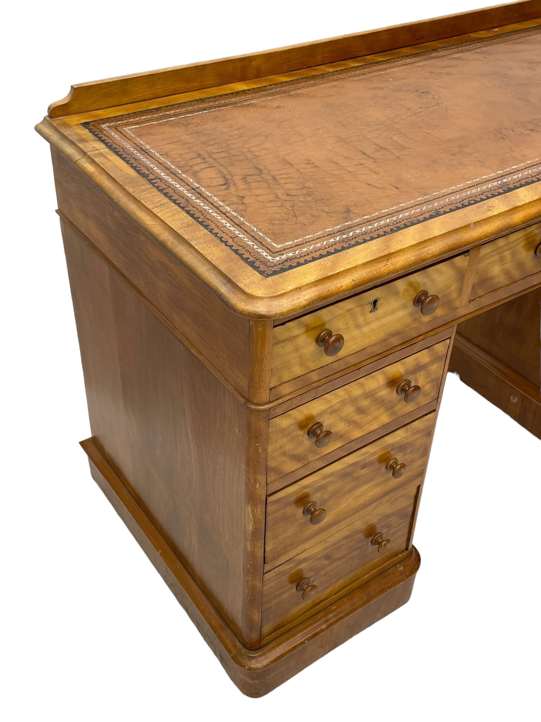 Victorian satin walnut twin pedestal desk, moulded rectangular top with rounded corners and raised back, inset leather writing surface with tooled borders, fitted with nine drawers with turned handles, on moulded plinth base 