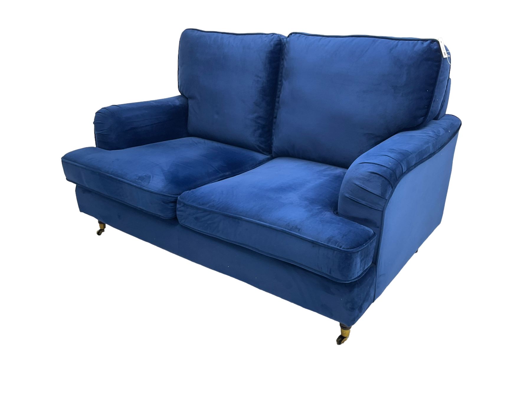 Howard design - two-seat sofa upholstered in blue fabric, traditional shape with rolled arms, on walnut finish turned feet with brushed metal cups and castors