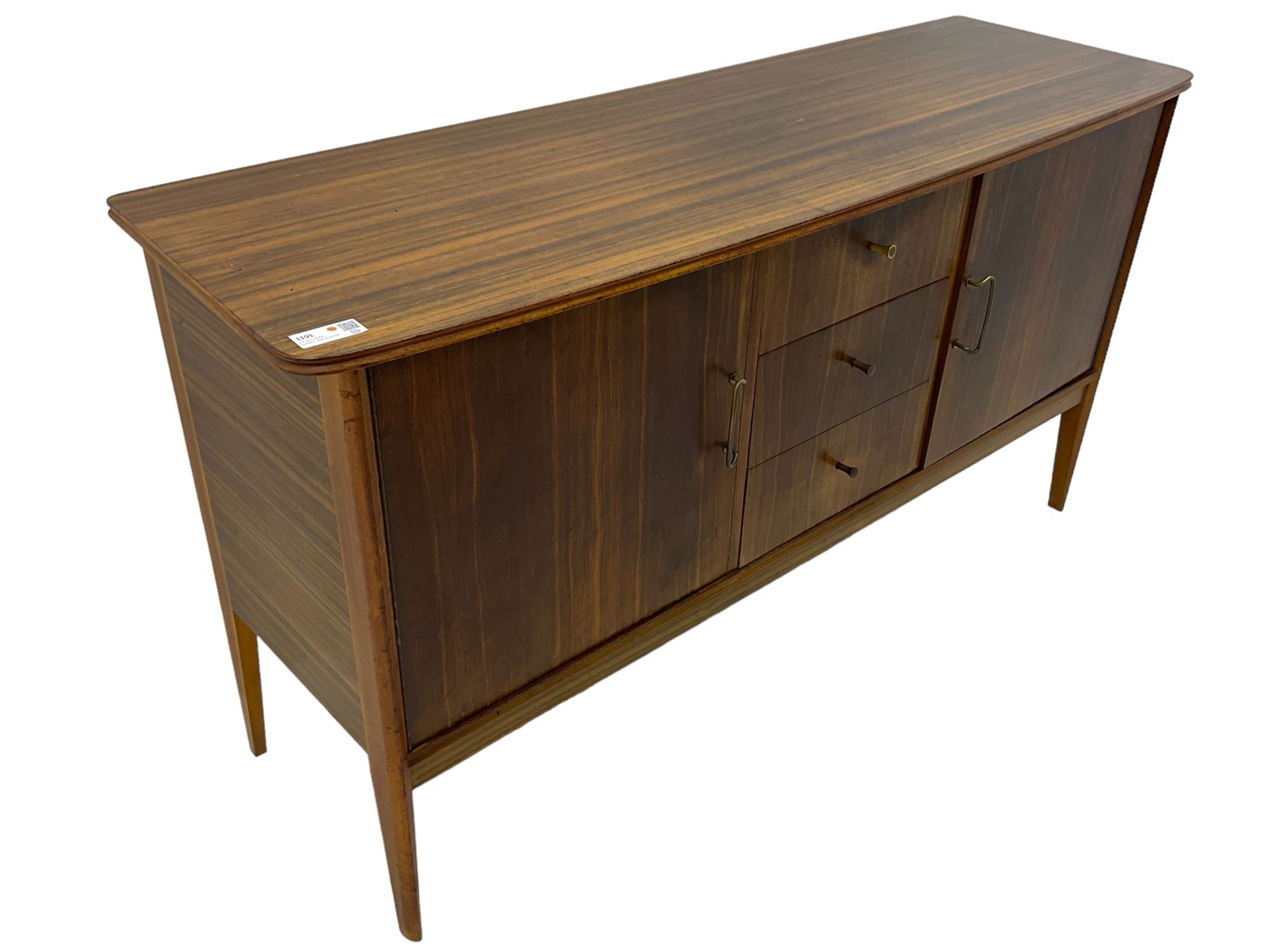 Mid 20th century teak sideboard, rectangular top with rounded corners over three central drawers, flanked by two cupboard doors enclosing shelves, raised on tapered supports